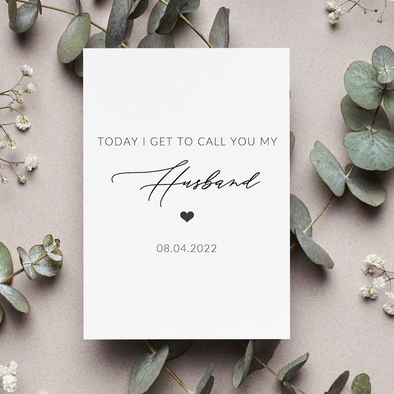 May include: White card with black text that reads "Today I get to call you my Husband" with a small heart symbol and the date "08.04.2022".