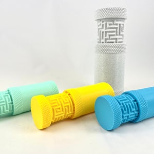 May include: Four stackable containers with a geometric pattern. The containers are in shades of blue, green, yellow, and white.