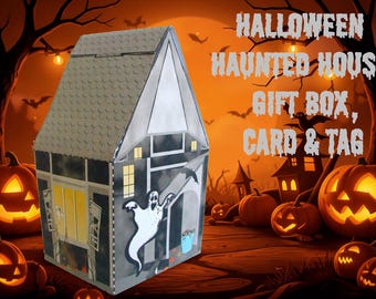 May include: A house-shaped gift box featuring a printed haunted house design with a white ghost, yellow windows, and a textured roof. The box displays the text HALLOWEEN HAUNTED HOUSE GIFT BOX, CARD & TAG on the side against a dark background.