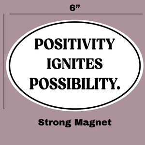 May include: White oval-shaped magnet with black text that reads "POSITIVITY IGNITES POSSIBILITY." The magnet is 6 inches wide and 4 inches tall. Strong magnet.