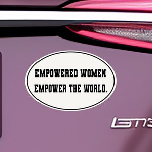 May include: A white oval sticker with black text that reads "Empowered Women Empower the World."