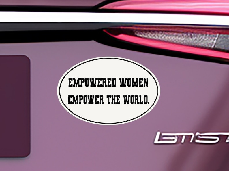 May include: A white oval sticker with black text that reads "Empowered Women Empower the World."