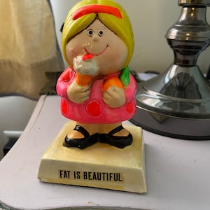 Vintage 60s Pride Creations fluorescent pink yellow haired girl licking ice cream figurine base says Fat is Beautiful