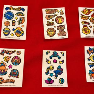 May include: A set of 10 colorful zodiac sticker sheets. Each sheet features a different zodiac sign with its corresponding symbol and personality traits. The stickers are perfect for adding a touch of personality to your planner, journal, or laptop.