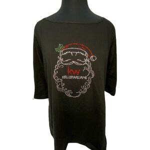 May include: Black long-sleeved shirt with a rhinestone design of Santa Claus's face with the text "Keller Williams" on the shirt.