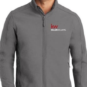 May include: A gray soft-shell jacket with a zipper closure and two pockets. The jacket has a red and white embroidered logo that says "kw KELLERWILLIAMS."