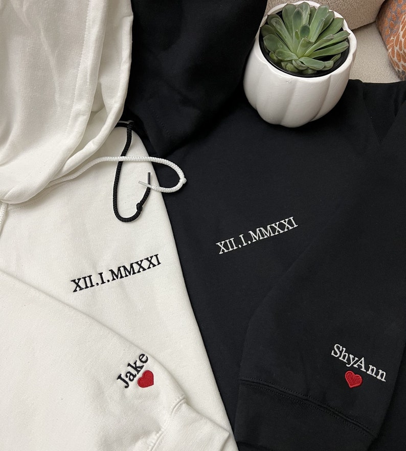 Custom embroidered roman numeral date sweatshirts for couples. Matching hoodies with name and heart on sleeve will make the perfect matching outfits for you and your loved one. Best sweatshirt gifts for your anniversary, Valentine's day.