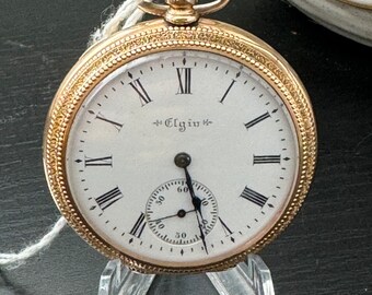 Reloj de bolsillo vintage con borde de moneda Elgin