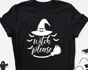 May include: Black t-shirt with a white witch hat, bats, and the phrase "witch please." The shirt is paired with black and white sneakers. Halloween-themed decorations include a spiderweb, ghosts, and bats.