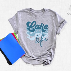 May include: Gray t-shirt with a blue and white graphic that says "Lake life" in a retro font.
