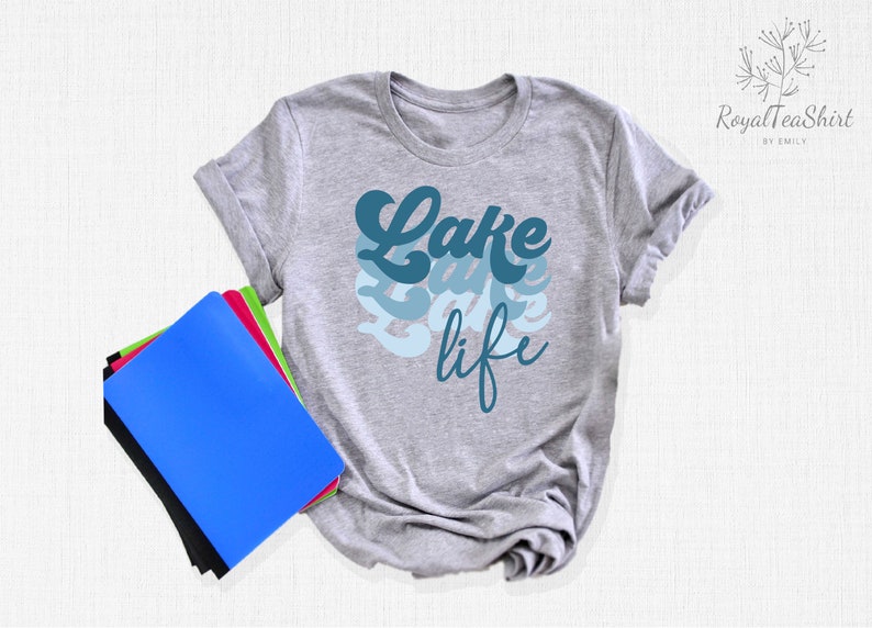 May include: Gray t-shirt with a blue and white graphic that says "Lake life" in a retro font.