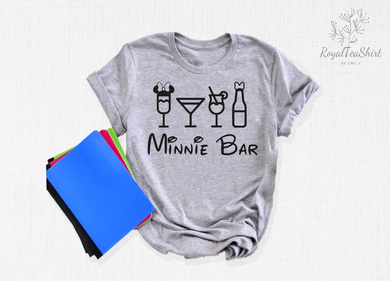 May include: Gray t-shirt with a black graphic of Minnie Mouse ears and four drink icons. The text "Minnie Bar" is below the icons.