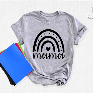 May include: A grey t-shirt with a black rainbow design and the word "mama" underneath. The rainbow has a small heart in the centre.
