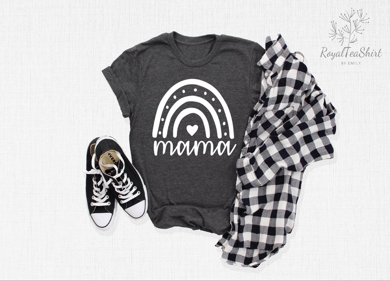 May include: A dark grey t-shirt with a white rainbow and the word "mama" printed on the front. The rainbow has a small white heart in the centre.