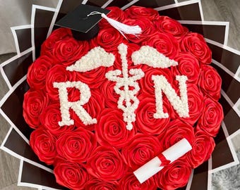 RN Registered Nurse Graduation Eternal red rose Bouquet w/ graduation cap, diploma and baby breath RN letters and caduceus symbol
