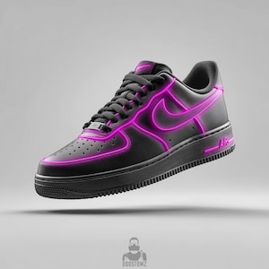 May include: Black and pink Air Force 1 sneakers with a glowing neon pink outline. The Nike swoosh and the word "AIR" are also in pink. The shoe is on a gray background.