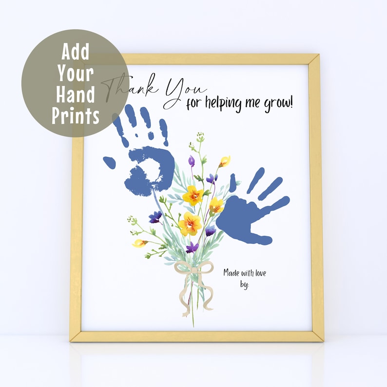 May include: A framed print with a gold border. The print features blue handprints, a floral bouquet with yellow and purple flowers, and the text "Thank You for helping me grow!" The print also includes the text "Add Your Hand Prints" and "Made with love by".