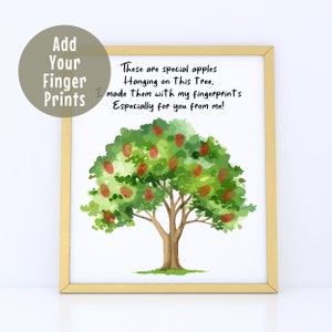 May include: A framed watercolor print featuring a tree with red fingerprint apples. The text reads, "These are special apples hanging on this tree. I made them with my fingerprints especially for you from me!" A circle graphic says "Add Your Finger Prints."