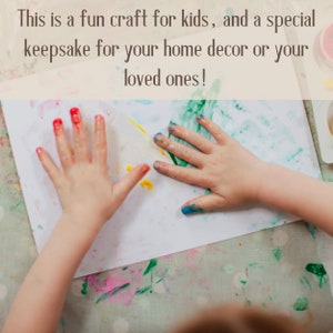 May include: A child's hands covered in red, yellow, blue, and green paint are pressed onto a white sheet of paper. The text above reads, "This is a fun craft for kids, and a special keepsake for your home decor or your loved ones!"