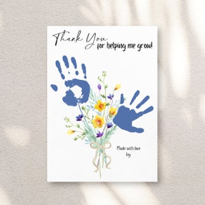May include: A white card with the text "Thank You for helping me grow!" features blue handprints and a watercolor bouquet of yellow, purple, and green flowers. The words "Made with love by" are also included.