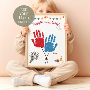 May include: A framed print with the text "Happy Birthday, Daddy!" and the words "Add Your Hand Prints". The print features red and blue handprints designed as balloons, with party-themed illustrations. The frame is a light wood color.