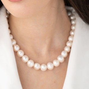 large pearl necklace on the model made with cultured freshwater 12mm round white pearls, includes stainless steel toggle clasp