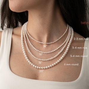 Real freshwater pearl necklace on the model. She wears round and tiny rice pearl necklace.