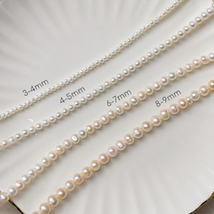 May include: Four strands of white pearl necklaces of varying sizes, displayed on a white plate with a gold rim. The strands are labeled with their pearl sizes: 3-4mm, 4-5mm, 6-7mm, and 8-9mm. The pearls have a lustrous sheen.