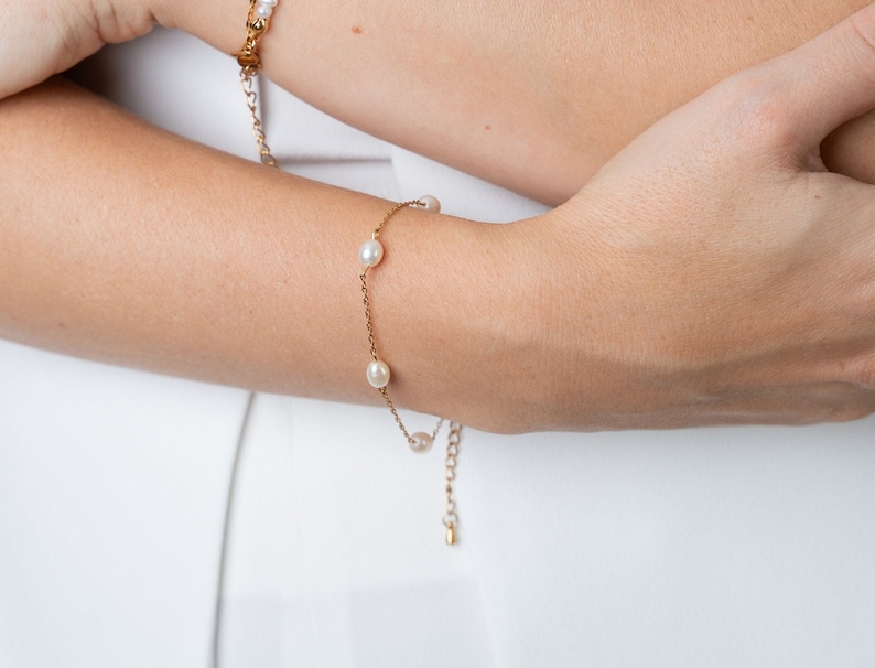 dainty pearl bracelet on a model. gold pearl bracelet with extension