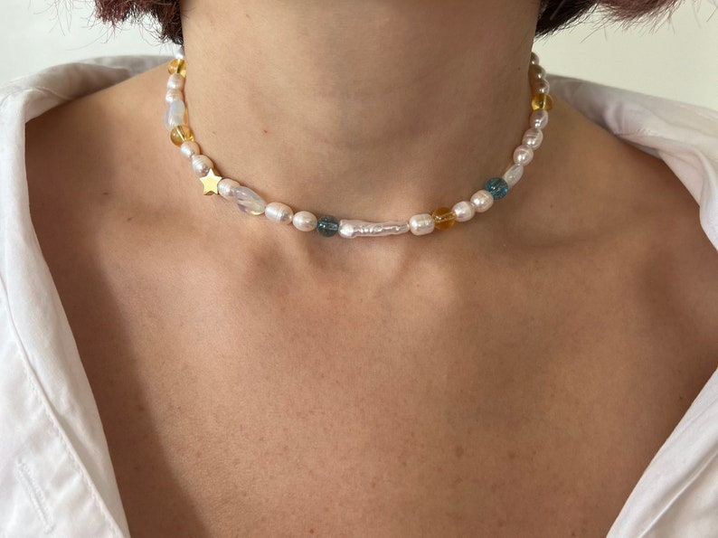 mismatched pearl and bead necklace with blue and yellow beads, star charm and stick biwa pearl, necklace choker on the model