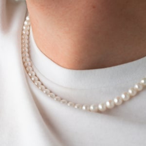 mens pearl necklace on the model, 8mm round white freshwater cultured pearls with stainless steel lobster clasp