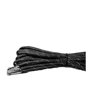 May include: Black shoelaces with a reflective thread woven into the fabric. The shoelaces are bundled together and tied with a black band.