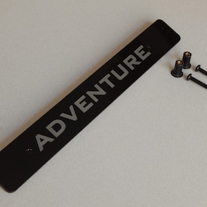 License Plate Delete laser cut and engraved &quot;ADVENTURE&quot; from acrylic for Subaru WRX models with factory JDM 10mm holes 210mm apart