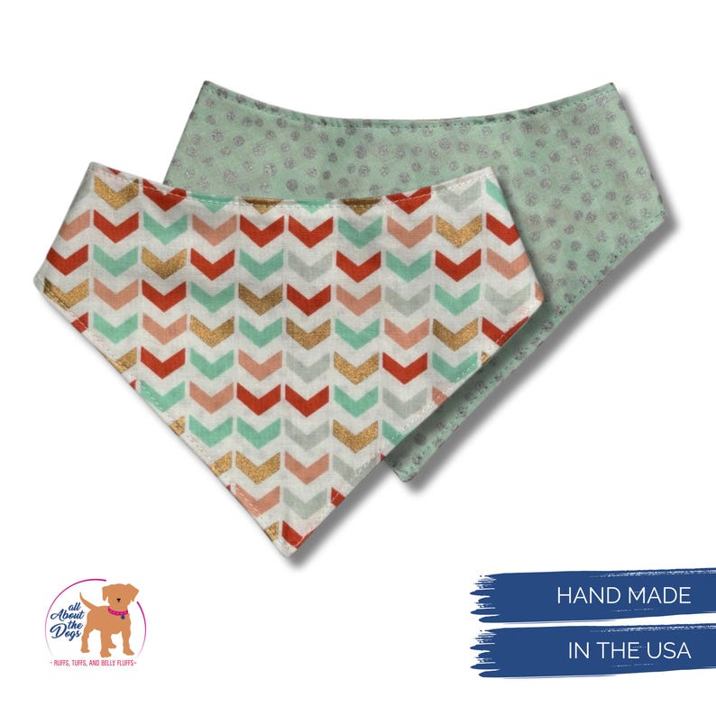 May include: Two dog bandanas. One features a chevron pattern in red, gold, mint, and peach. The other is mint green with a small dot pattern. The bandanas are handmade in the USA.
