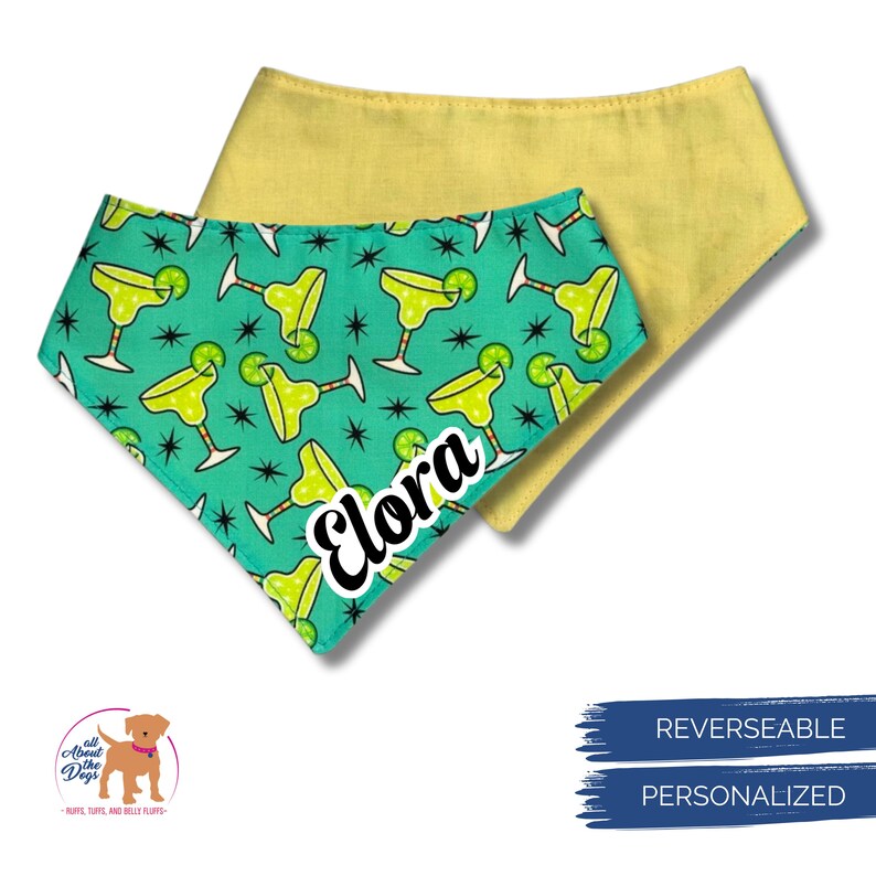May include: Two reversible dog bandanas. One is yellow, the other is teal with a margarita pattern and the name "Elora". The bandanas are personalized and reversible.
