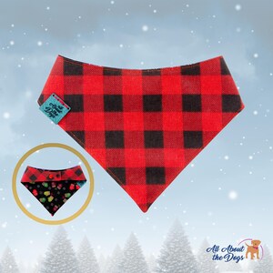 May include: Red and black buffalo plaid dog bandana with a small, turquoise tag that reads "All About the Dogs." A smaller, inset image shows a second bandana with a black background and colorful mitten and snowflake pattern.