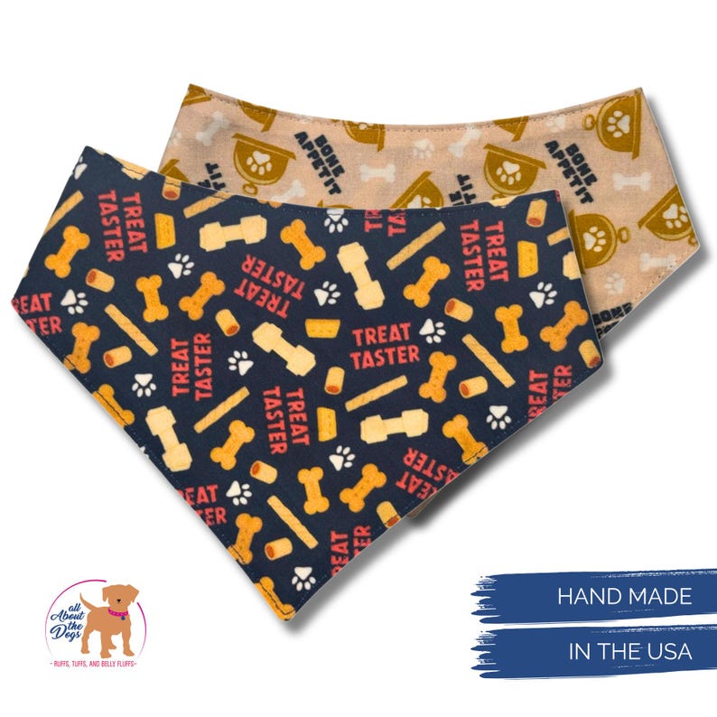 May include: Two dog bandanas. One is navy blue with bone, treat, and paw print patterns, and the text "TREAT TASTER". The other is tan with bone and bowl patterns, and the text "BONE APPETIT". The bandanas are handmade in the USA.