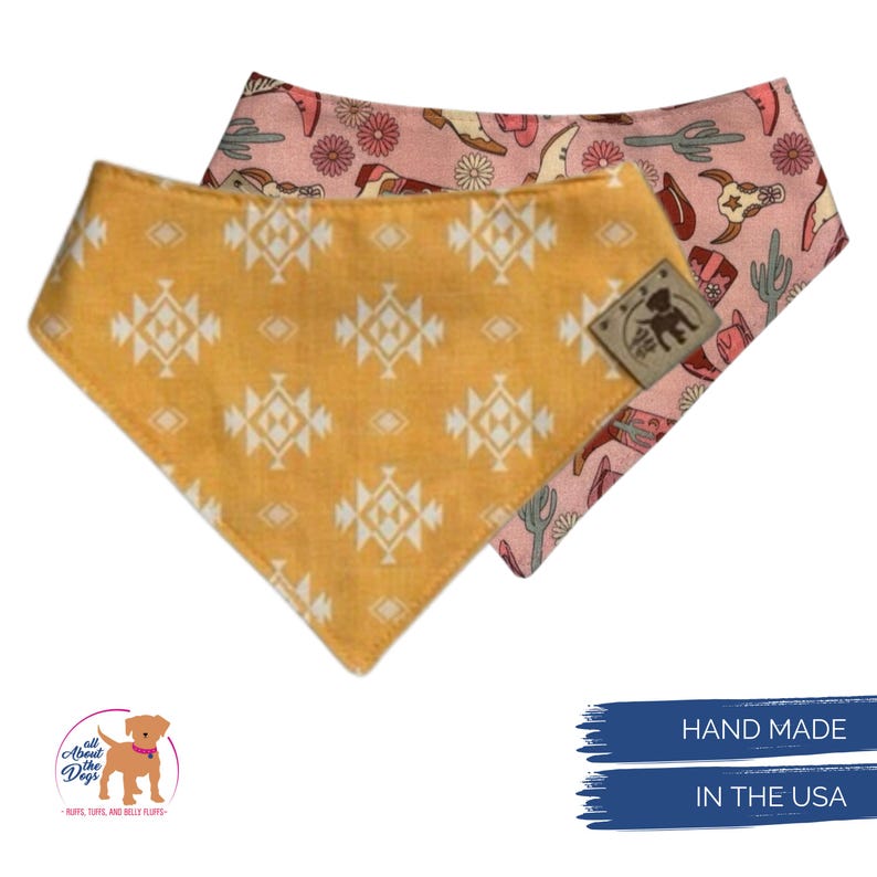 May include: Two dog bandanas. One is mustard yellow with a white geometric pattern. The other is pink with a cowboy-themed print. The bandanas are handmade in the USA.
