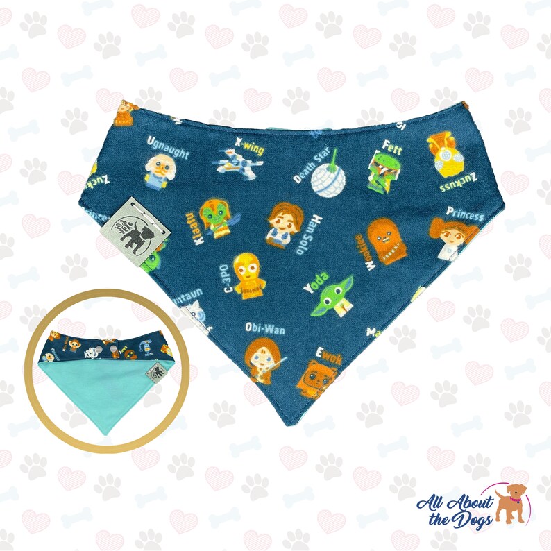 May include: A blue bandana featuring a Star Wars theme. The bandana depicts various characters from the Star Wars universe, including Yoda, Han Solo, Princess Leia, and Chewbacca. The bandana is reversible, with a light blue colour on the reverse side.