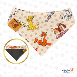 May include: A pink and white dog bandana with a polka dot pattern. The bandana features cartoon images of Simba from The Lion King, Tod from The Fox and the Hound, and Copper from The Fox and the Hound. The bandana also has the words "Sumba", "Tod", "Copper", "Pepper", and "Thumper" printed on it.