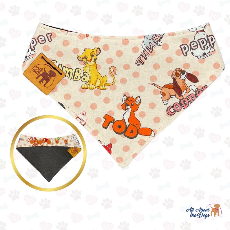 May include: A pink and white dog bandana with a polka dot pattern. The bandana features cartoon images of Simba from The Lion King, Tod from The Fox and the Hound, and Copper from The Fox and the Hound. The bandana also has the words "Sumba", "Tod", "Copper", "Pepper", and "Thumper" printed on it.