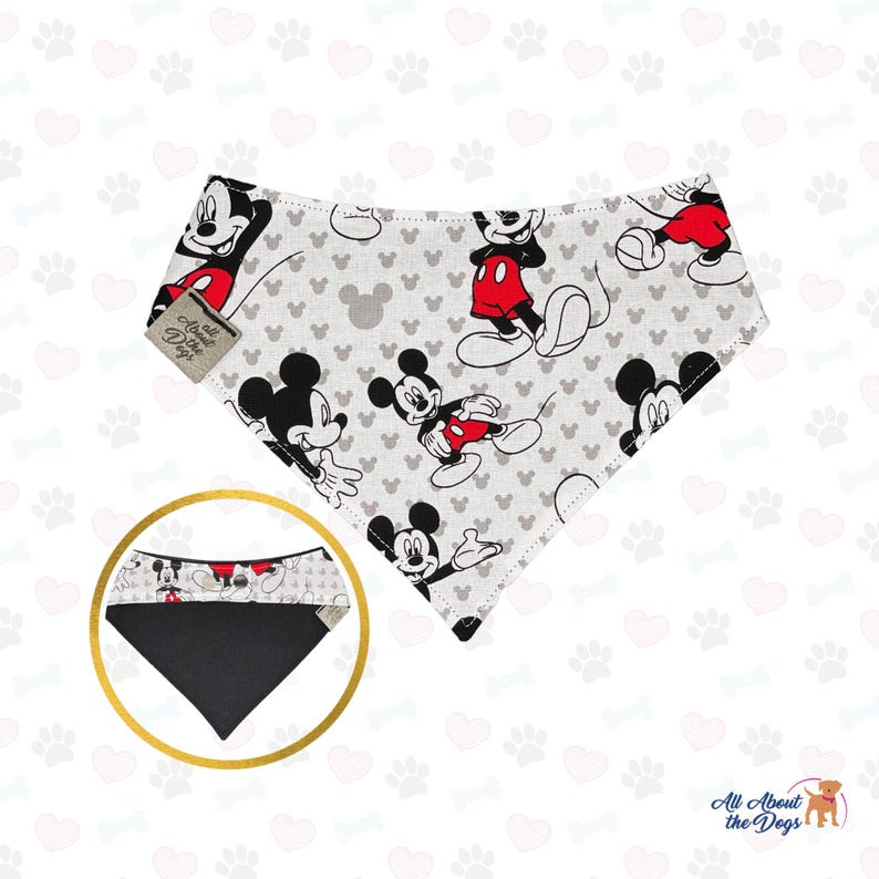 May include: A dog bandana with a repeating pattern of Mickey Mouse in black, red, and white on a light grey background. The bandana has a black reverse side and a tag that reads "All About the Dogs".