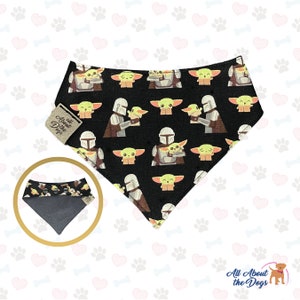 May include: Black bandana with a repeating pattern of a green alien character and a Mandalorian character. The bandana is reversible with a gray side. The bandana has the text "All About the Dogs" on it.