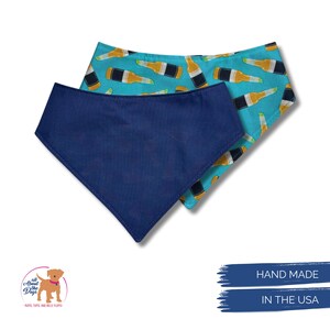 May include: Two dog bandanas. One is solid navy blue, the other has a light blue background with a pattern of beer bottles. The bandanas are handmade in the USA. The logo for "All About Dogs" is in the lower left corner.