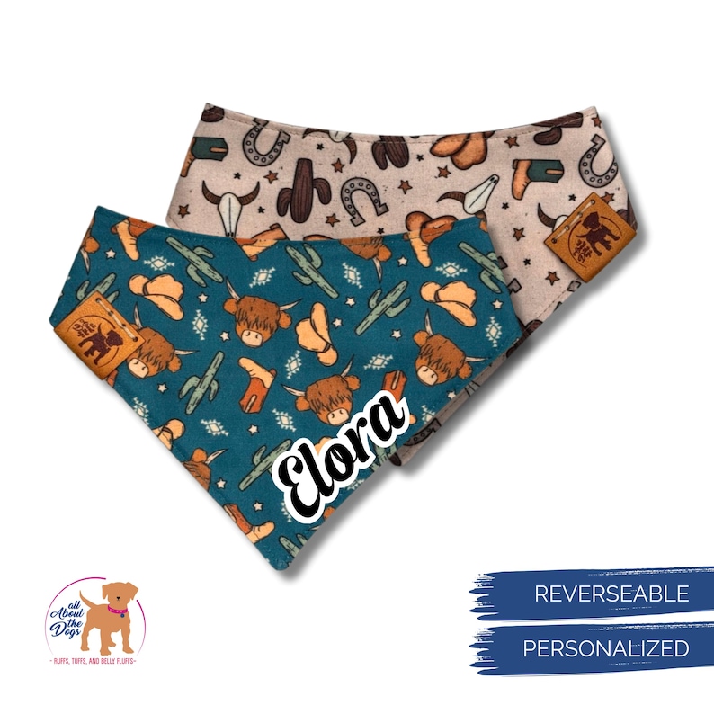 May include: Two reversible dog bandanas with a western theme. One is teal with Highland cow, cactus, and hat patterns. The other is tan with horseshoe, boot, and steer skull patterns. The teal bandana has the name "Elora" on it.