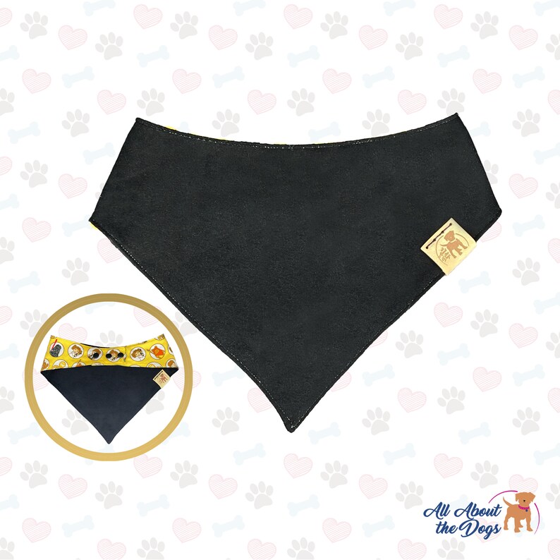May include: Black dog bandana with a yellow and white pattern of dogs on the edges. The bandana has a small brown label with a dog silhouette on it. The text "All About the Dogs" is printed in white on a brown background.