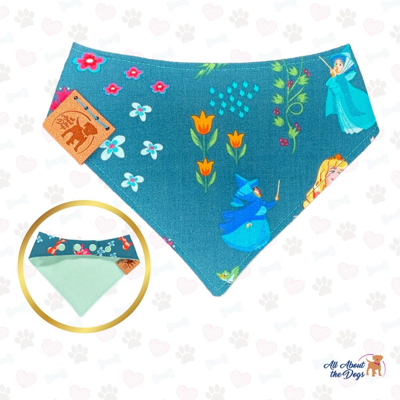 May include: Teal dog bandana with a colourful floral and fairy tale design. The bandana features illustrations of fairies, flowers, and the text "All About the Dogs". Includes a smaller, reversible bandana with a coordinating pattern.