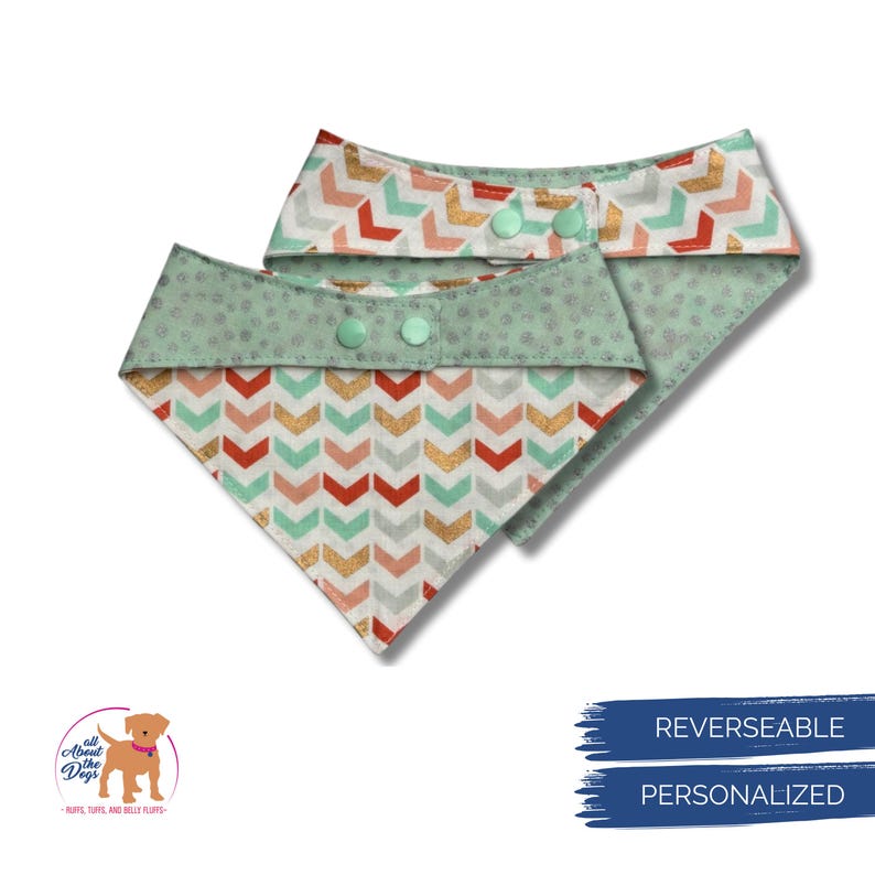May include: Two reversible dog bandanas. One bandana features a mint green polka dot pattern on the reverse side and a chevron pattern in red, gold, and mint green on the front. The other bandana has a similar chevron pattern and a mint green polka dot pattern.