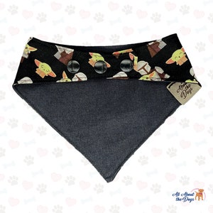 May include: Black and green dog bandana with a pattern of cartoon baby Yoda characters. The bandana has a black snap closure and a brown leather tag that says "All About the Dogs".