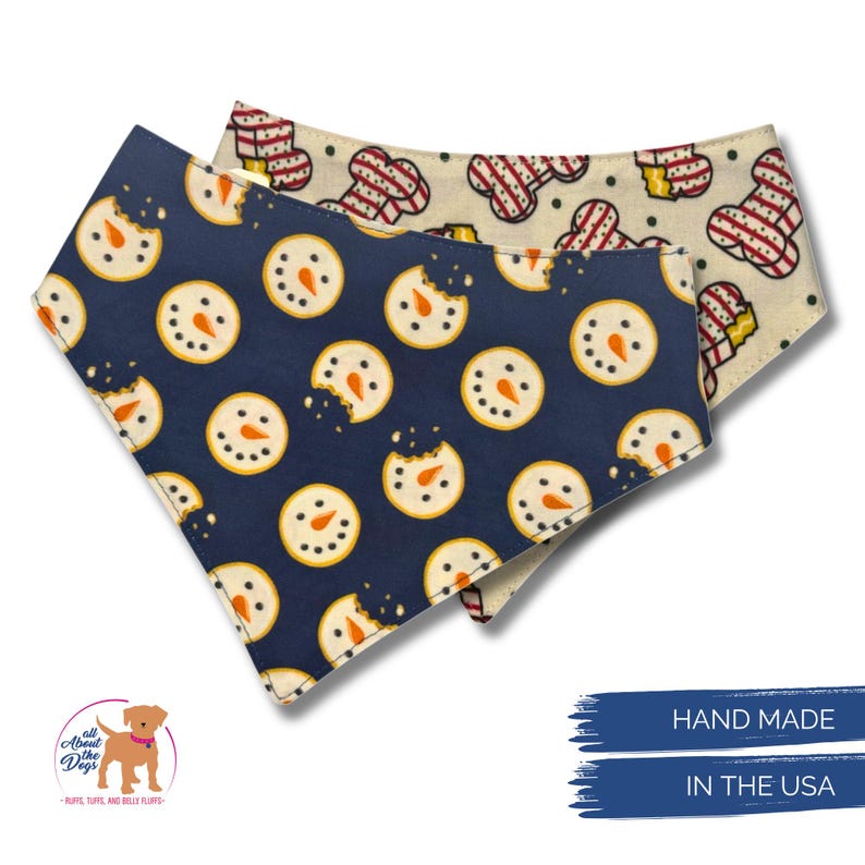 May include: Two dog bandanas with festive patterns. One is navy blue with snowman cookie designs, and the other is off-white with gingerbread man designs. The bandanas are handmade in the USA.